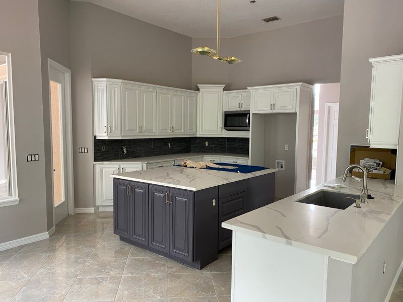 Billko cabinet painting project: white perimeter cabinetry with dark island