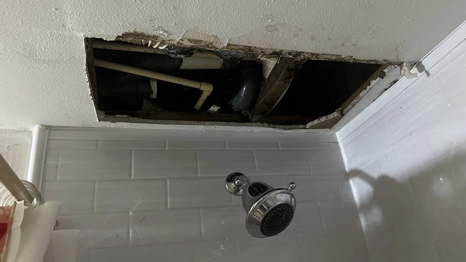 Before ceiling repair with access opening above shower