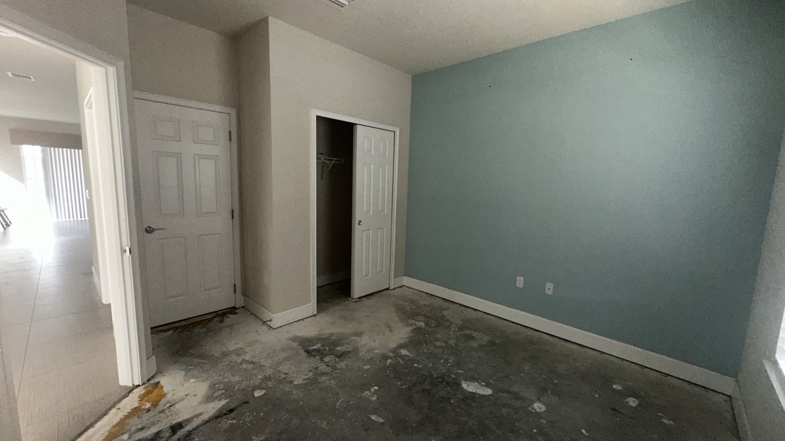 Finished residential room with blue accent wall and painted trim