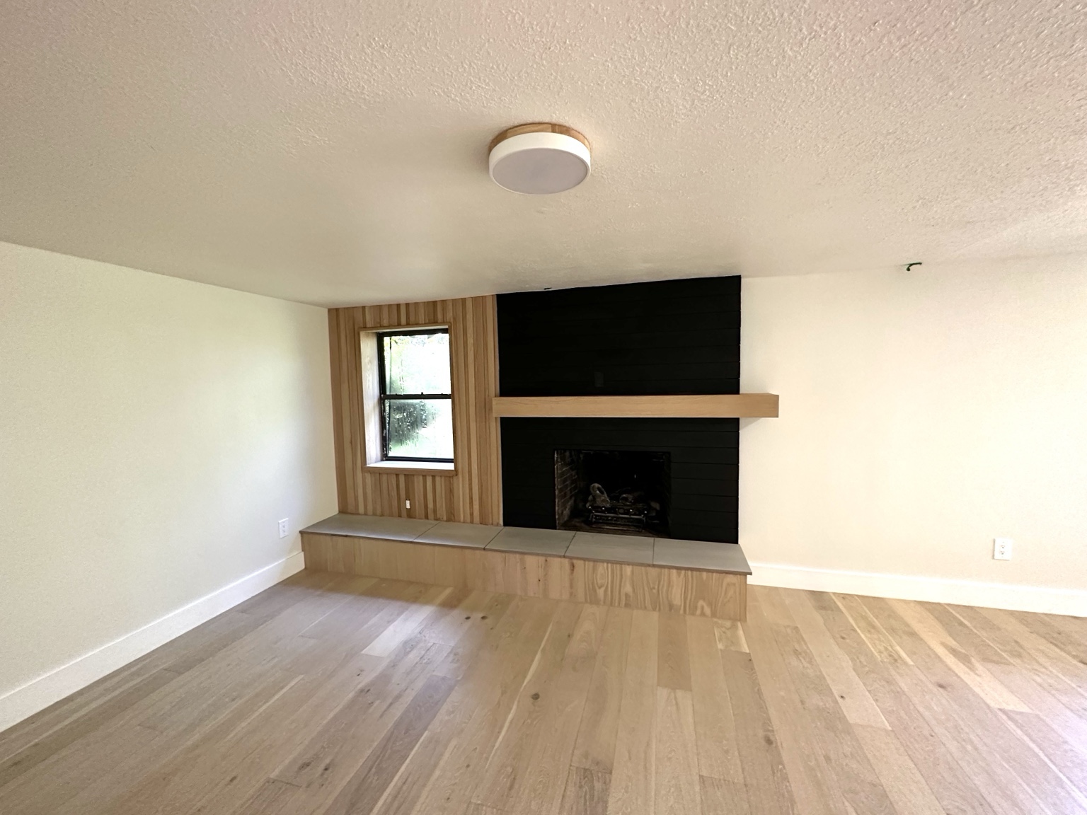 Finished residential living room with fireplace and painted walls